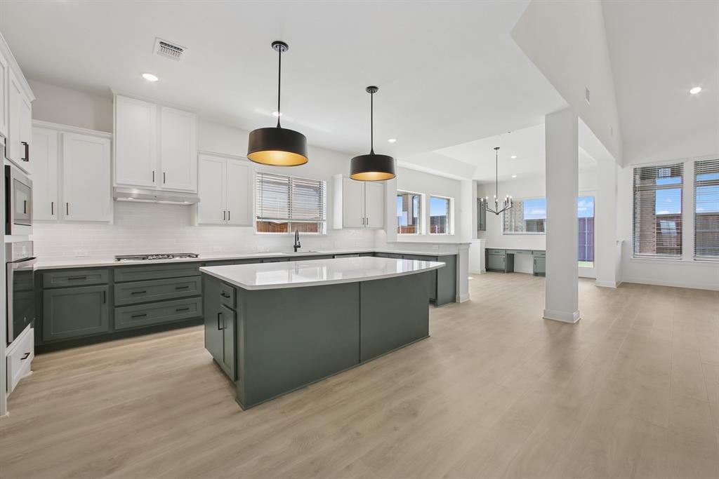 605 Derby Drive Mansfield, TX 76063 - Photo 10 of 13 a kitchen with stainless steel appliances kitchen island granite countertop a sink a stove and a wooden floors