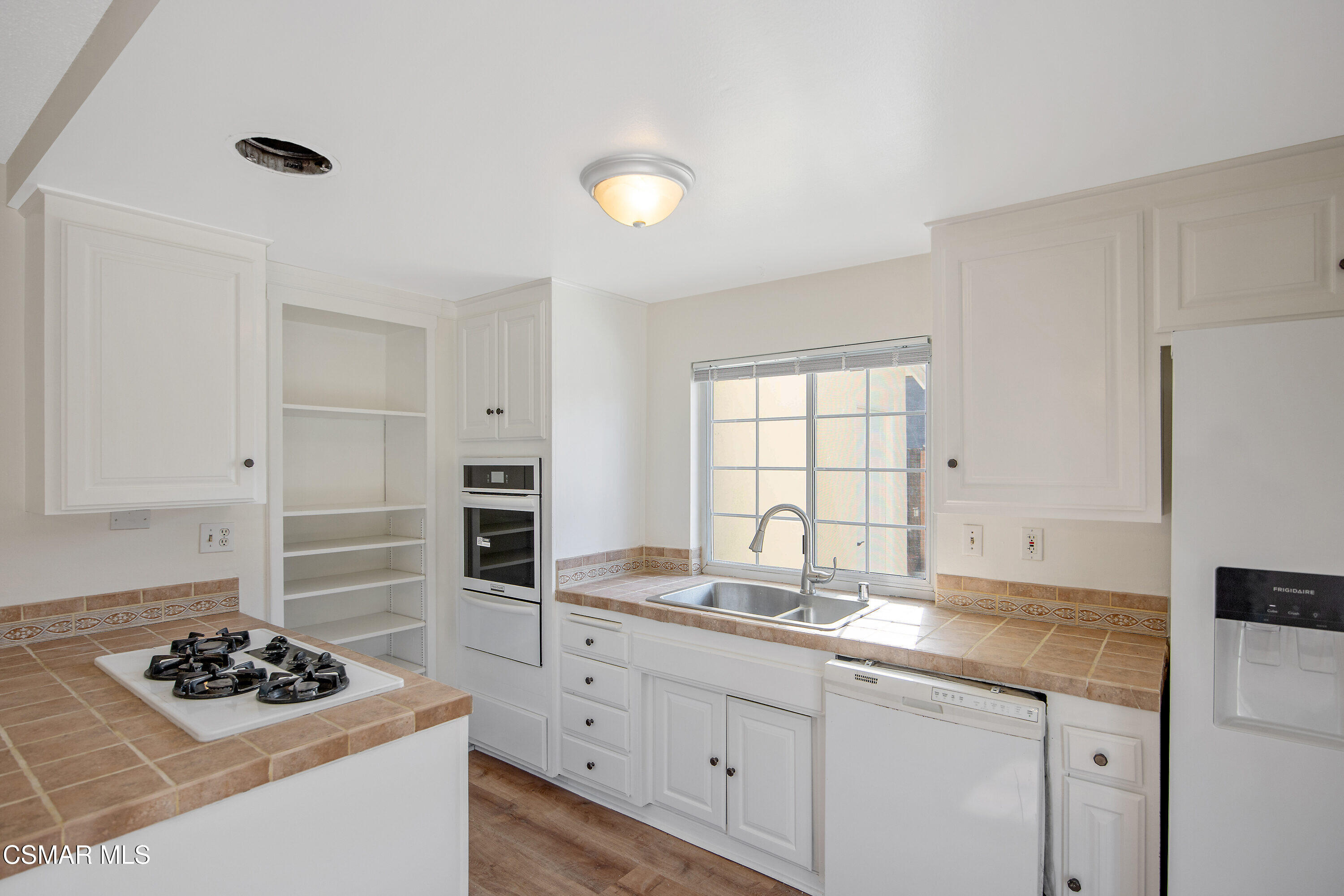 2087 Rhoda Street Simi Valley, CA 93065 - Photo 5 of 22 a kitchen with stainless steel appliances kitchen island granite countertop a sink stove and cabinets