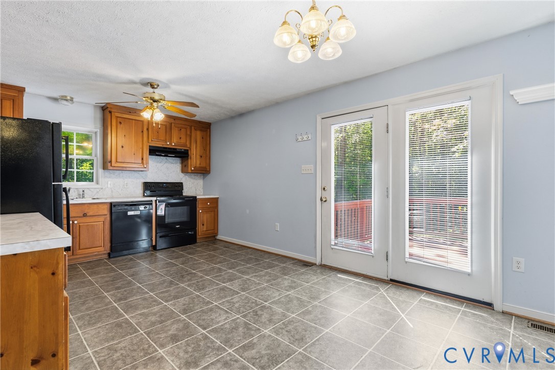 12654 Mt Olive Cohoke Road West Point, VA 23181 - Photo 11 of 31 a kitchen with stainless steel appliances a stove a sink a microwave a counter top space and cabinets