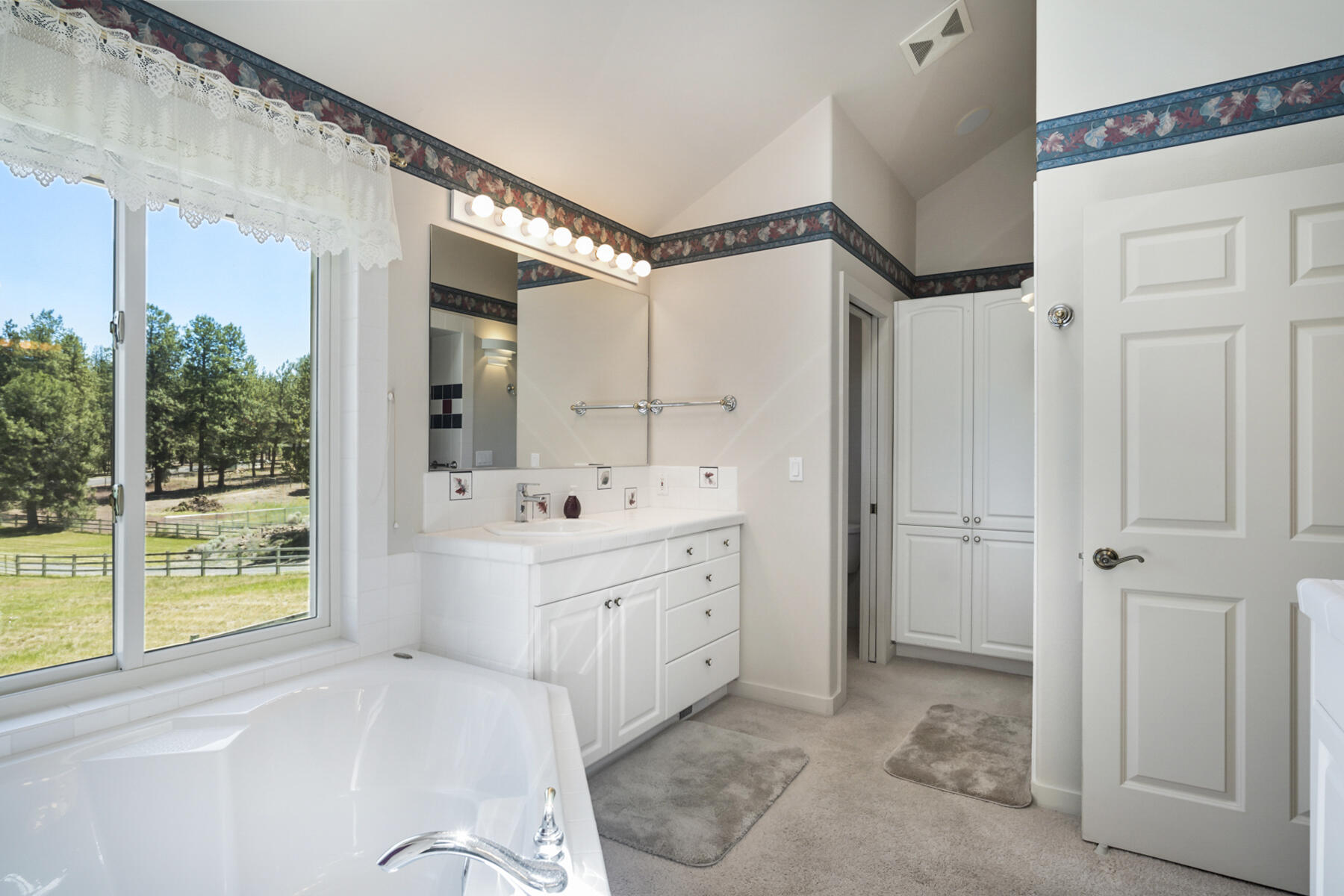 60696 Tekampe Road Bend, OR 97702 - Photo 36 of 61 a bathroom with a sink mirror and a bathtub
