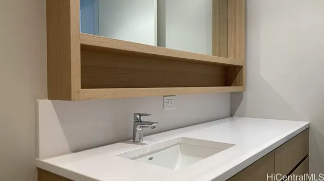 a bathroom with a sink and a mirror