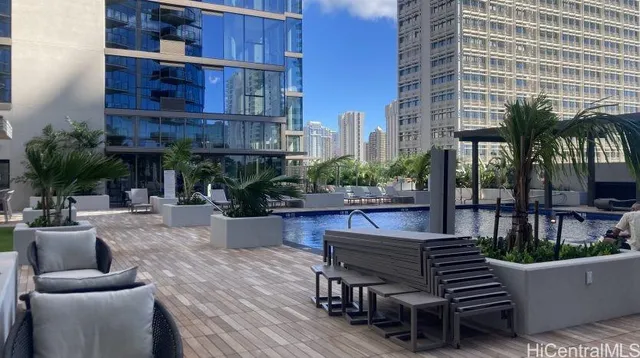 a swimming pool with outdoor seating and yard