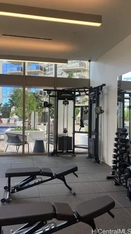 a room with gym equipment and floor to ceiling window