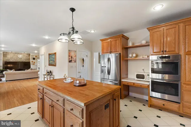 a kitchen with stainless steel appliances a sink stove and refrigerator