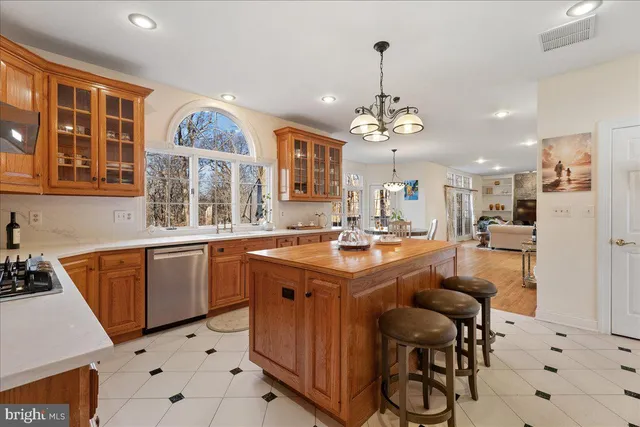 a kitchen with granite countertop a sink appliances and cabinets
