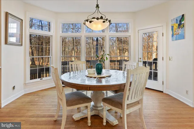 a view of a dining room with furniture wooden floor and chandelier