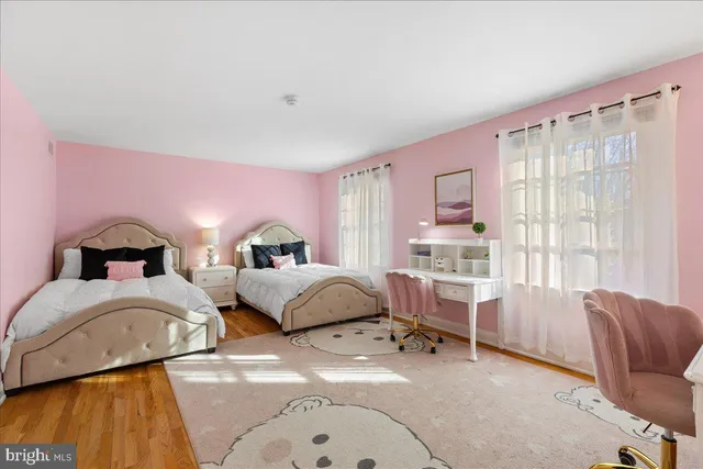 a bedroom with two beds and a large window
