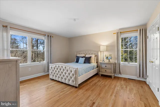 a room with a bed and wooden floor