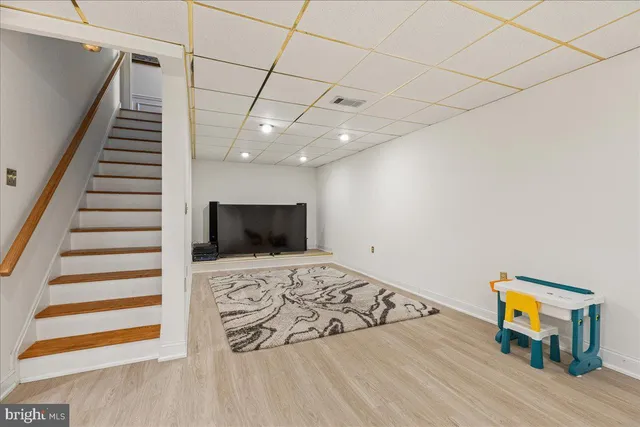 a view of a livingroom with wooden floor and furniture