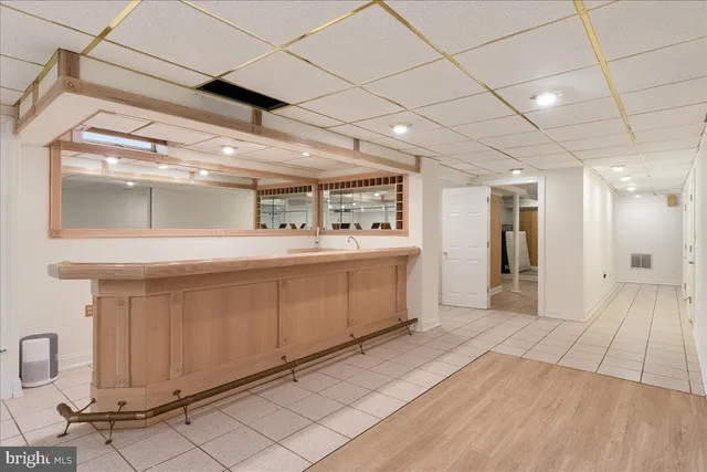 a bathroom with a sink mirror and a shower