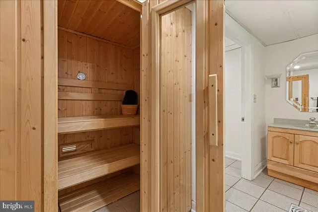 a view of bathroom with a sink and mirror