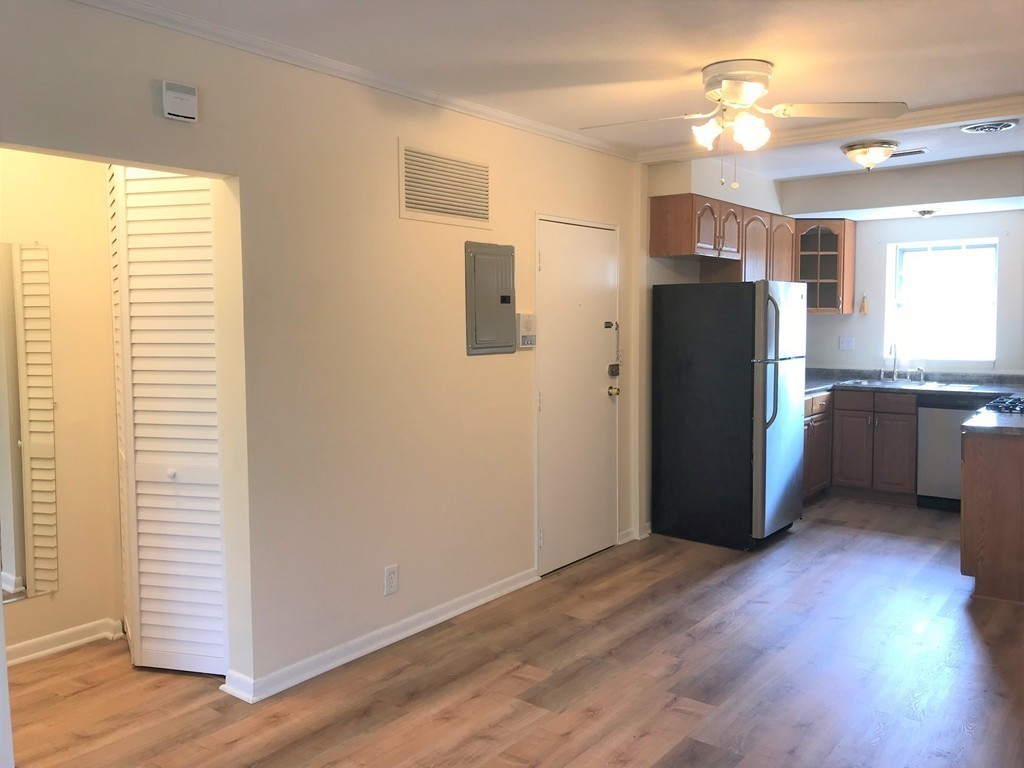 157 Lake Shore Road, Unit 4 Boston, MA 02135 - Photo 2 of 11 a view of a kitchen with a refrigerator and a stove top oven