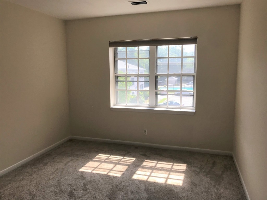 157 Lake Shore Road, Unit 4 Boston, MA 02135 - Photo 7 of 11 an empty room with a window