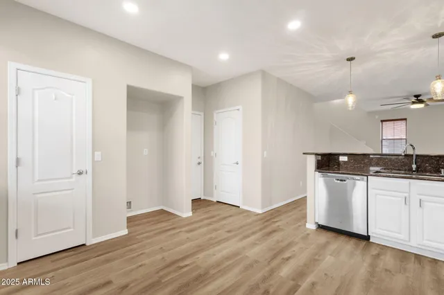 a view of a kitchen with a sink and a refrigerator