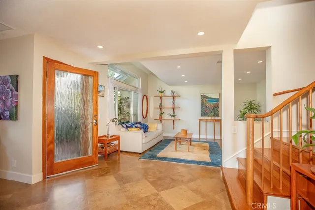 a living room with a large window and furniture