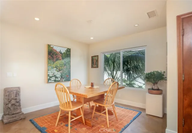a dining room with furniture and wooden floor