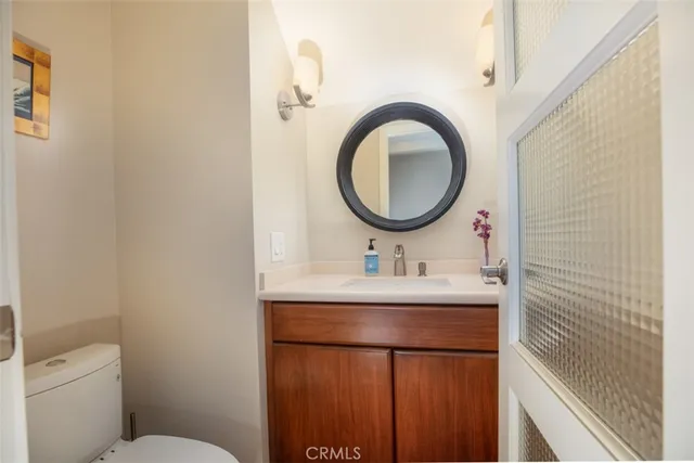 a bathroom with a toilet a sink and a mirror