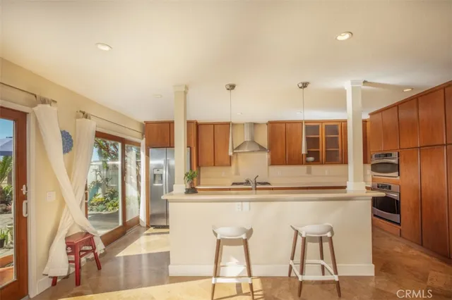 a kitchen with stainless steel appliances granite countertop a refrigerator and a stove top oven