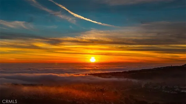 a bedroom with a bed and a large window with outer view