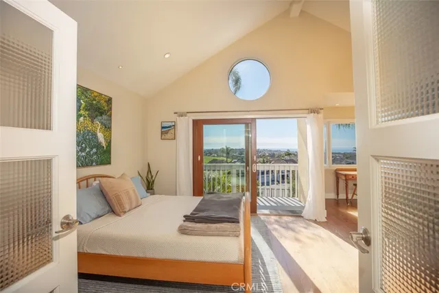 a bedroom with a large bed and a large window
