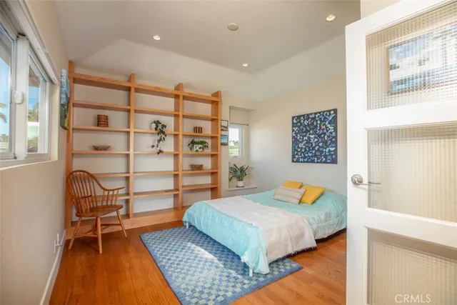 a view of a patio with chairs potted plants and a large tree