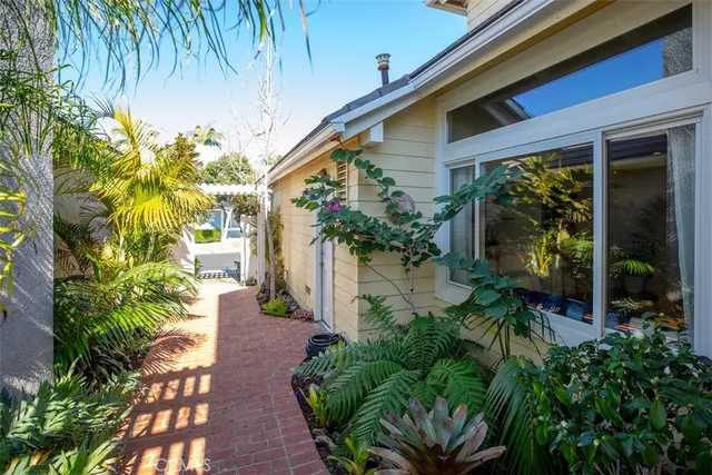 a front view of multi story residential apartment building with a garden