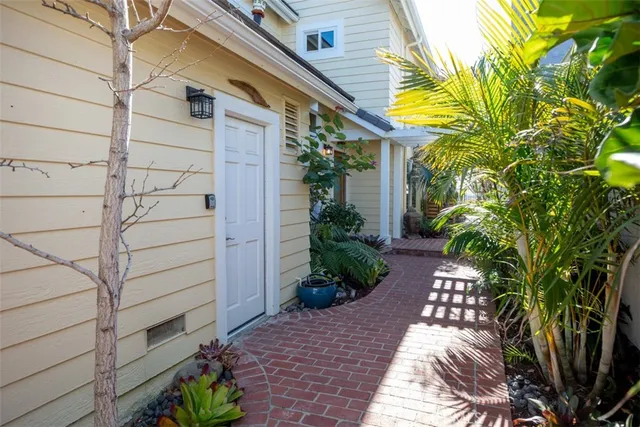a house with potted plants in front of door