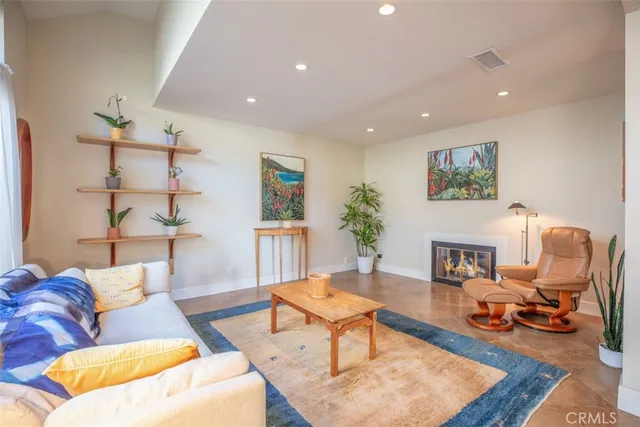 a living room with furniture a rug and a painting