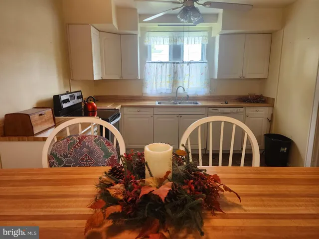 a living room with a chandelier furniture and a window