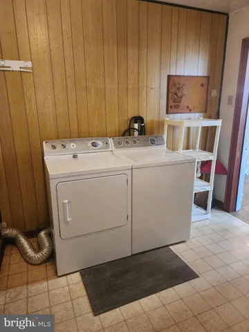 a room with a washing machine and cabinets