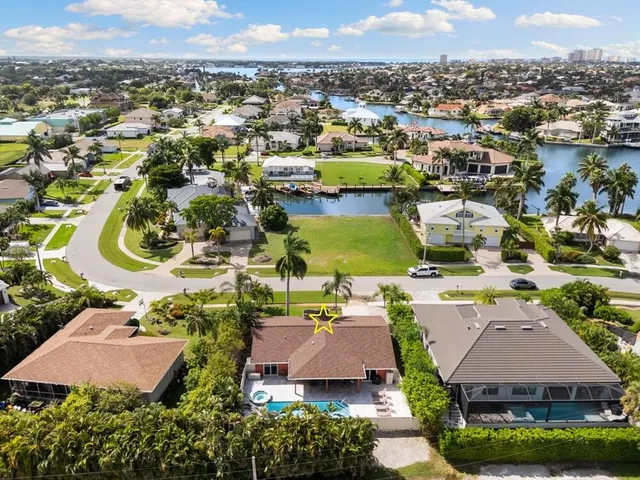 an aerial view of residential houses with outdoor space and swimming pool