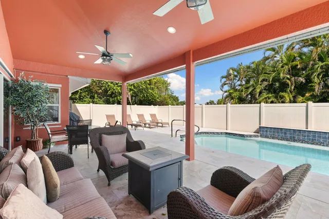 an aerial view of a house with a garden and lake view