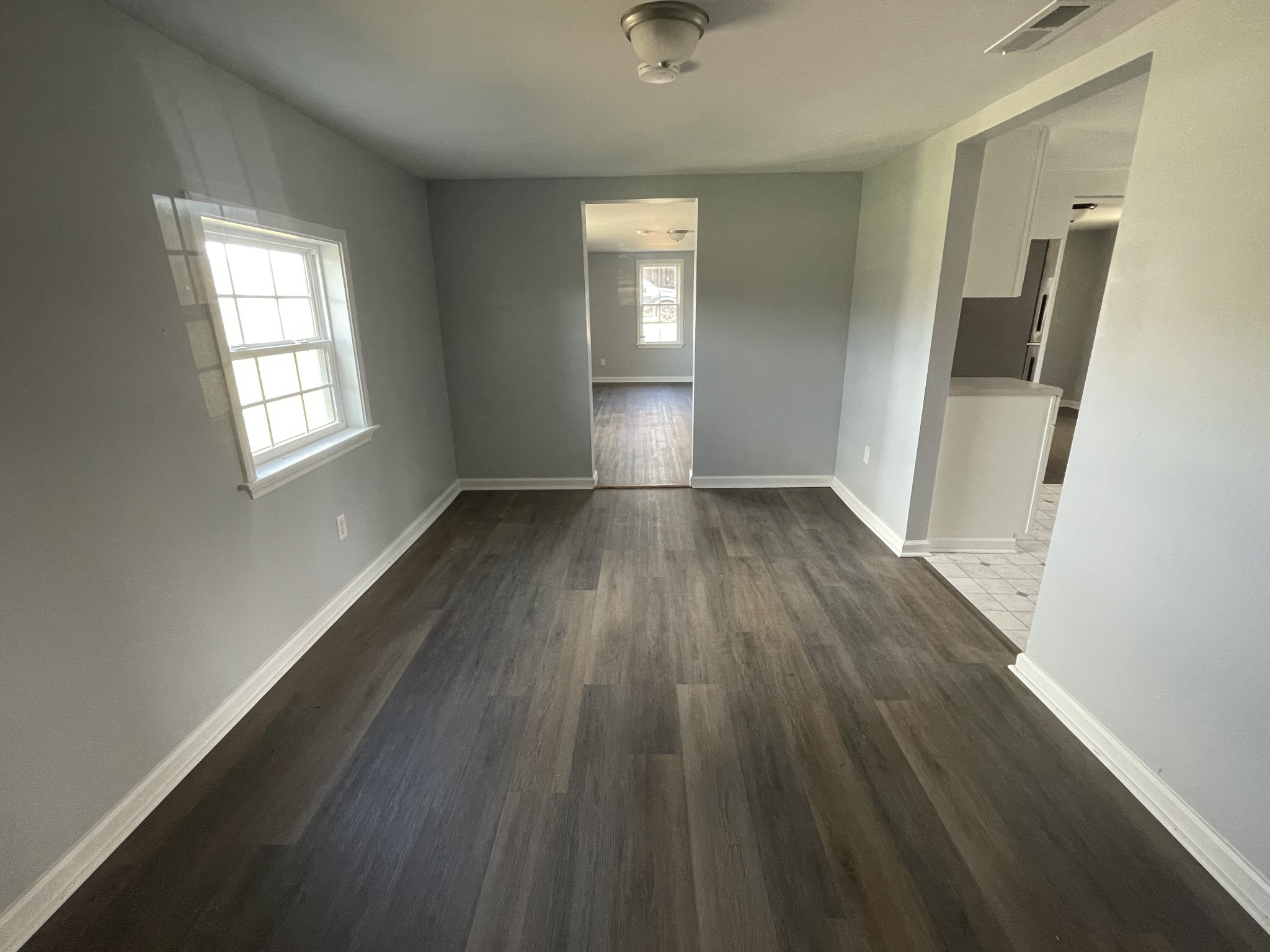 1808 Grays Bend Road Centerville, TN 37033 - Photo 9 of 18 an empty room with wooden floor and windows