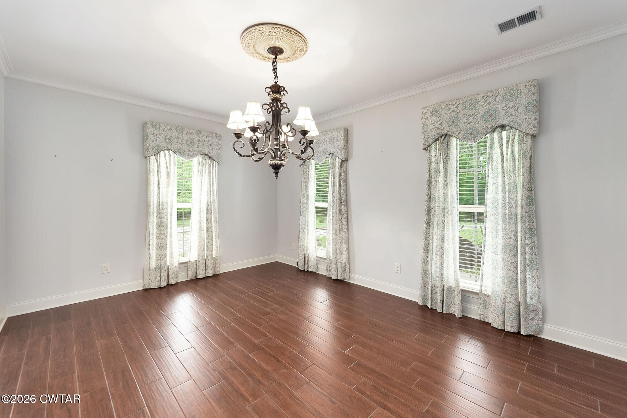 4080 Beech Bluff Road Beech Bluff, TN 38313 - Photo 12 of 41 a view of a livingroom with wooden floor and chandelier