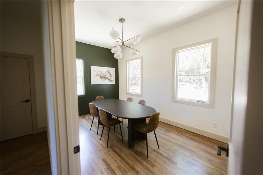 6700 Shady Grove Road Cumming, GA 30041 - Photo 41 of 69 a dining room with chandelier and wooden floor