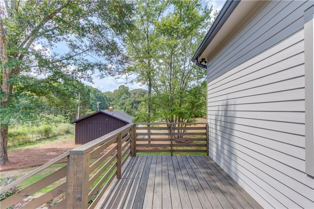 6700 Shady Grove Road Cumming, GA 30041 - Photo 45 of 69 a view of deck with wooden floor and fence and a floor to ceiling window