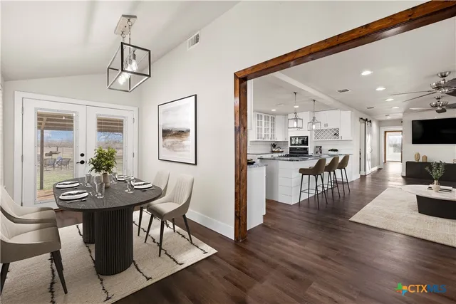 a view of a dining room with furniture wooden floor and a chandelier