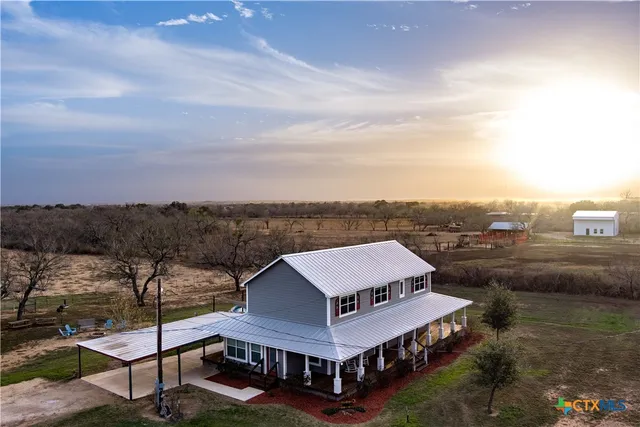 a aerial view of a house next to a yard