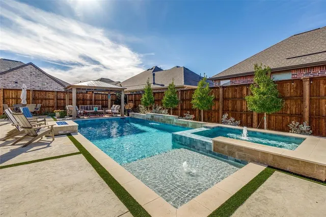 a view of a house with swimming pool and sitting area