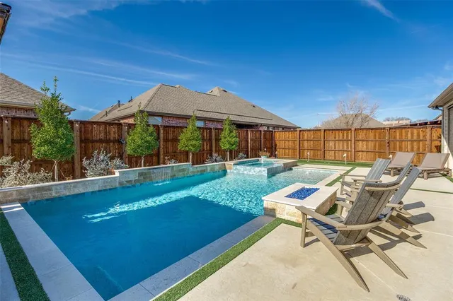 a view of a patio with table and chairs with wooden floor and fence