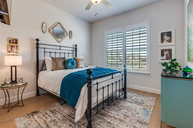 a bedroom with a bed a chandelier and a window