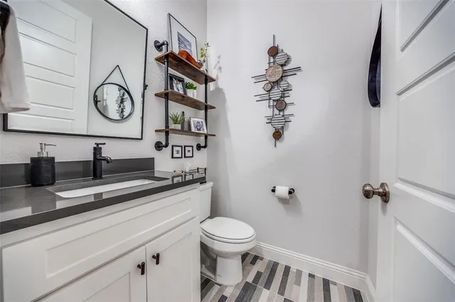 a bathroom with a toilet a sink and a mirror