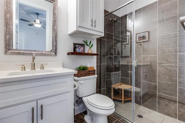 a bathroom with a shower toilet and sink