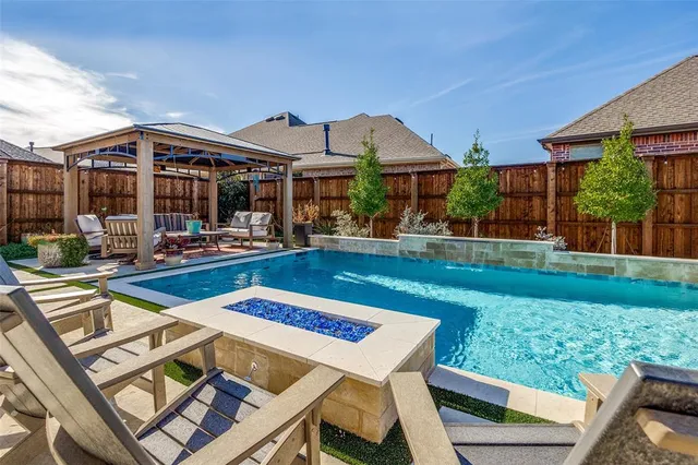 a view of a house with a backyard porch and sitting area