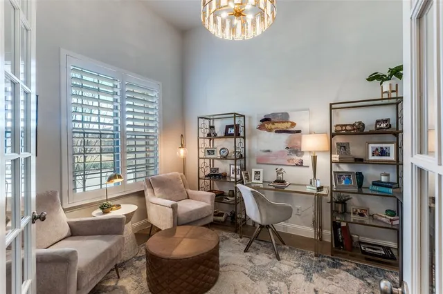 a living room with furniture a rug and a large window