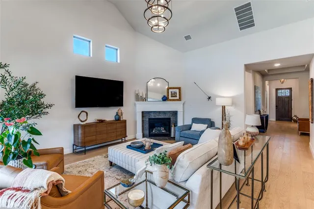 a living room with furniture a fireplace and a flat screen tv