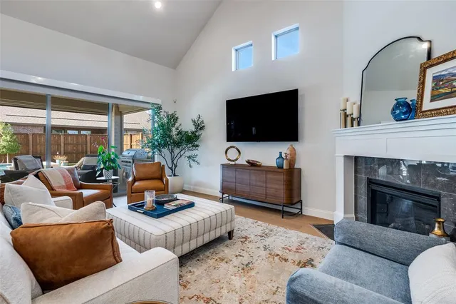 a living room with furniture a fireplace and a flat screen tv