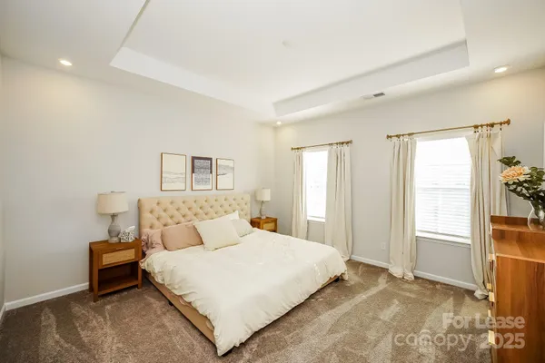 a spacious bathroom with a granite countertop sink mirror and a toilet