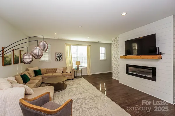 a kitchen with stainless steel appliances granite countertop a kitchen island hardwood floor sink stove and refrigerator