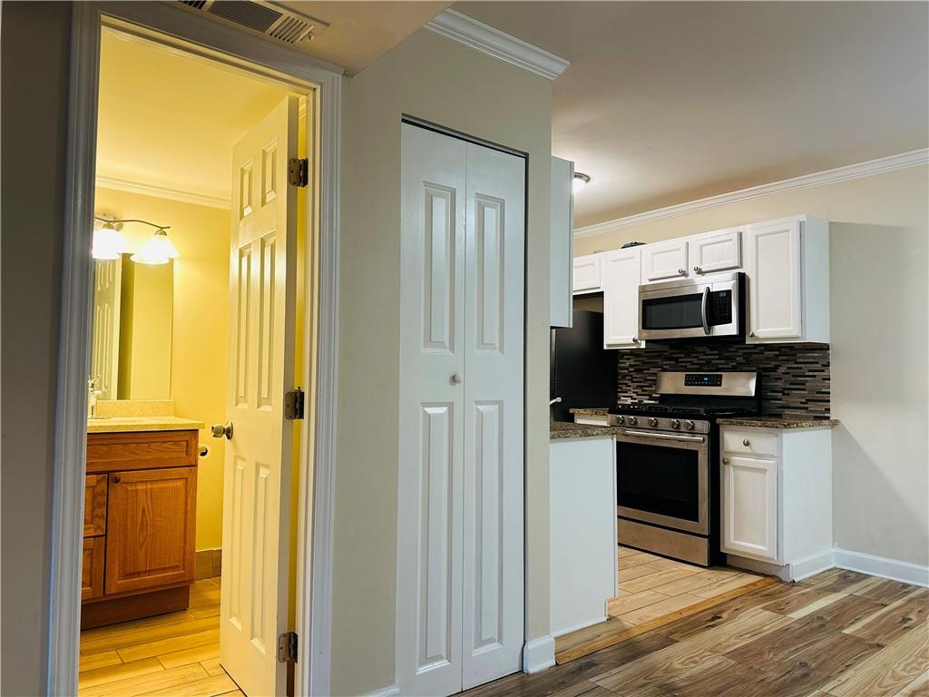 405 Fairburn Road Southwest, Unit 122 Atlanta, GA 30331 - Photo 4 of 26 a kitchen with stainless steel appliances granite countertop a refrigerator and a stove top oven